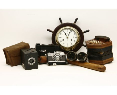 Sundries: a modern ship's wheel clock, inscribed 'Schatz,  Royal Mariner', an accordion, three cameras, binoculars, truncheon