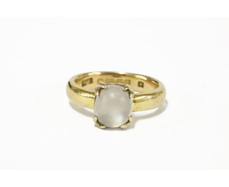 A single stone moonstone cabochon ring, on a replacement 22ct gold wedding ring6.03g