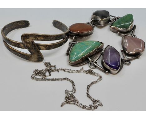 A bracelet of six irregular-shaped polished coloured stones mounted in white metal, stamped ST.SILV, maker's stamp WB or EM; 