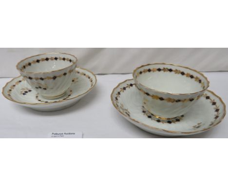 Two 19th century wrythen porcelain tea bowls and saucers, probably Worcester, each similarly decorated, white with cobalt blu