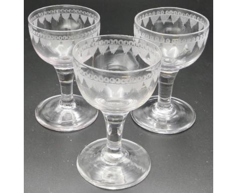 Set of three small wine glasses with drawn stems, the bowls engraved with a border of leaves, c1800, 8.4cm, with receipt from