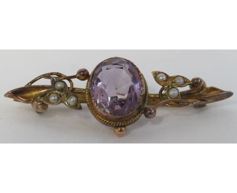 9 carat gold bar brooch set with a large amethyst (11mm x 10mm) and six seed pearls in scrolled leaf setting with spheres, le