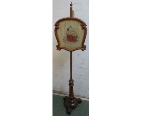 Victorian mahogany pole firescreen, adjustable escutcheon-shaped framed and glazed screen with needlework of seated mother an