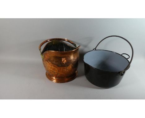 A Copper Helmet Shaped Coal Scuttle and an Enamelled Metal Jam Pan with Loop Handle 