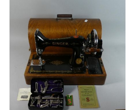 An Oak Cased Singer Sewing Machine with Tools 
