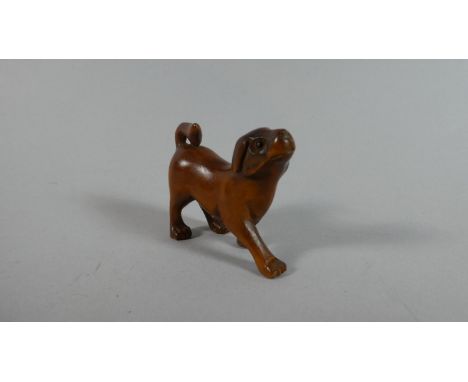 A Carved Wooden Netsuke in the Form of a Dog, 4cm High 