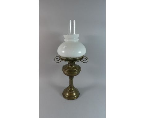 A Brass Oil Lamp with Opaque Glass Shade and Chimney, 62cm High 