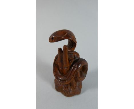 A Carved Wooden Netsuke in the Form of a Cobra Among Bamboo, 5.5cm High 