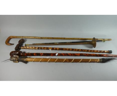 A Tribal Rain Stick, Short Copper Horn, Two Tribal Walking Sticks and a Shepherd's Crook etc 