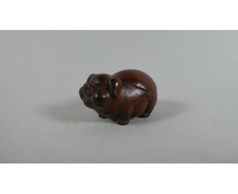 A Carved Wooden Netsuke in the form of a Portly Pig, 5cm Wide 