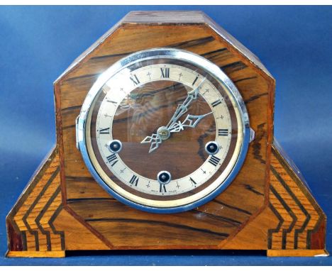 An art deco mantle clock, the case principally in oak with additional inlaid detail enclosing a three train movement within a