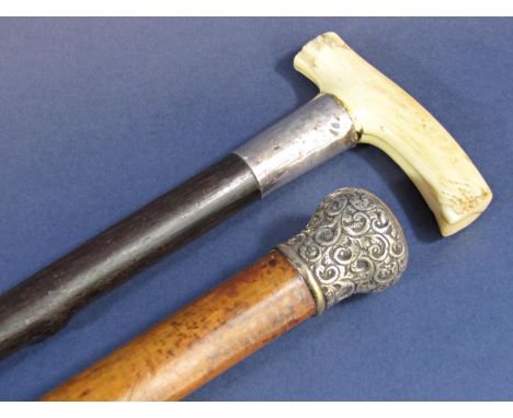 A malacca walking stick with a silver knob, and another example with a bone handle. 2 