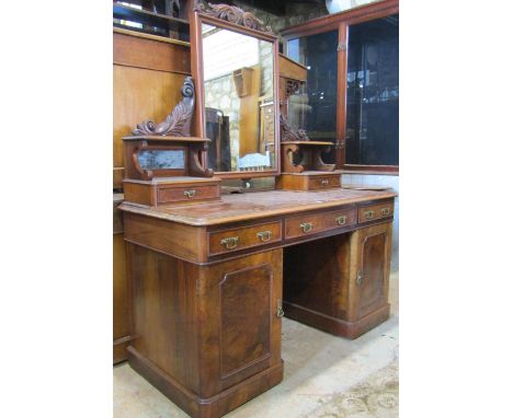 A good quality Victorian walnut kneehole twin pedestal dressing table the raised rectangular swing mirror and carved scrollin