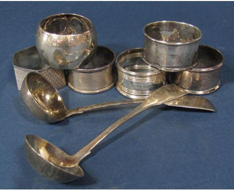 An Irish Georgian silver sauce ladle, Dublin 1818, by Laurence Nowlan, a similar Victorian ladle and six assorted napkin ring