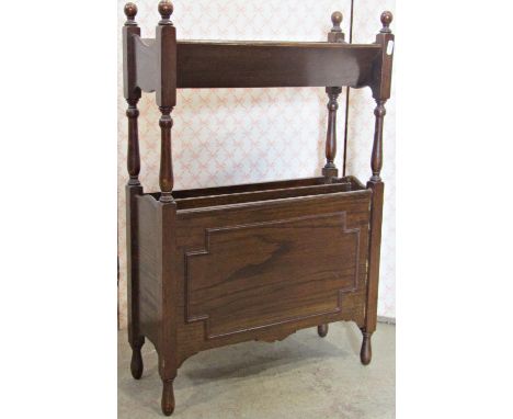 A small 1920s oak floorstanding two divisional Canterbury and combined book trough with applied geometric mouldings, 46 cm wi