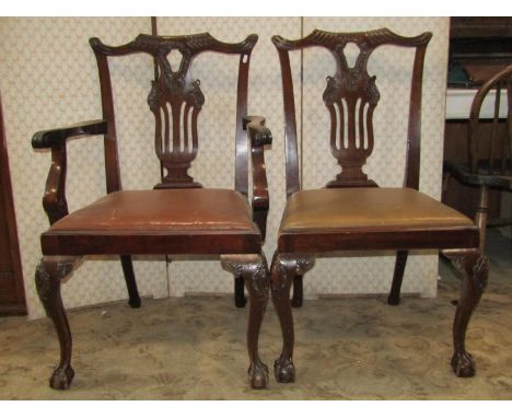A set of six (4+2) Chippendale style dining chairs, with carved and pierced splats, shaped cresting rails, drop in seats and 