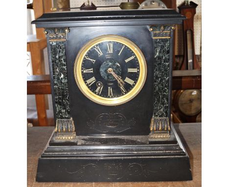 A mid-Victorian period black slate and marble mantle clock with eight day striking movement, key and pendulum 