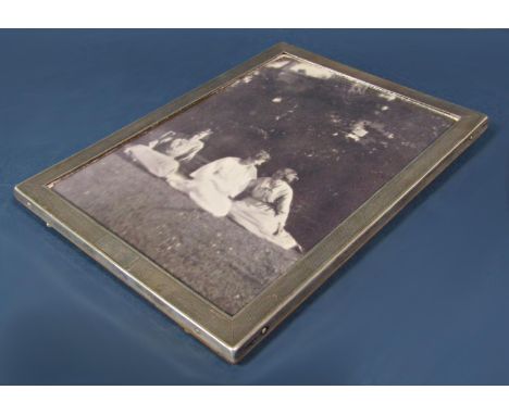 A silver early 20th century engine turned photo frame, 16cm wide x 22cm high 