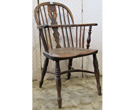 A 19th century Windsor low hoop and stick back elbow chair, principally in yew wood, with central pierced splat, over and elm