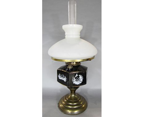 A Duplex oil lamp with a black and gold hexagonal decorated with a romantic scene. 56cm high. 