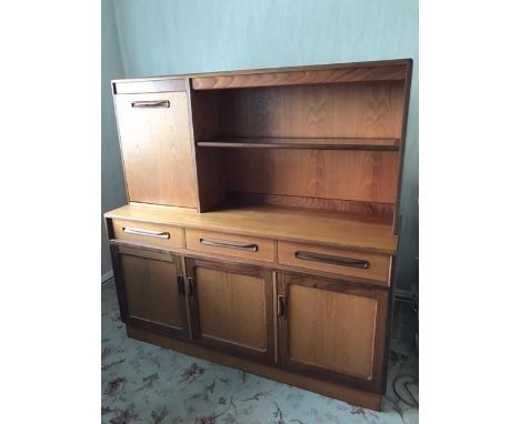 A G-Plan teak lounge unit, the base enclosed by three panelled doors and three frieze drawers with sculpture handles, beneath