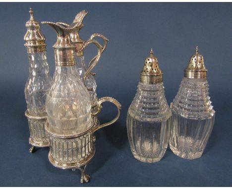 A Victorian silver cruet stand of three cut glass  bottles with silver necks and a pair of silver sugar shakers, 9oz approx 