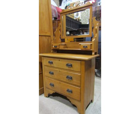 An Edwardian satin walnut dressing chest of three long drawers beneath a raised swing mirror with rectangular bevelled edge p