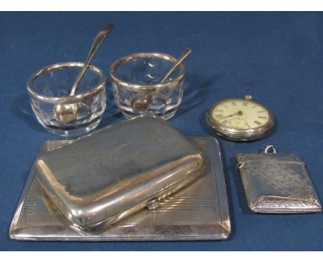 A silver cigarette case, a vesta, a smaller cigarette case, pocket watch, two glass salts with silver rims and two spoons, 7.