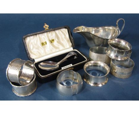 A mixed selection of 20th century silver ware including a small sauce boat christening spoon and eight assorted napkin rings,