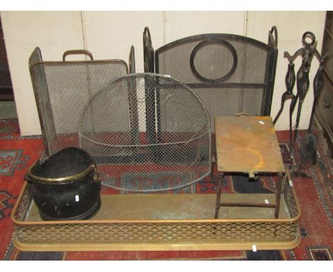 One lot of antique and later fireside ware/tools to include a pierced brass fender, two folding spark guards varying design, 