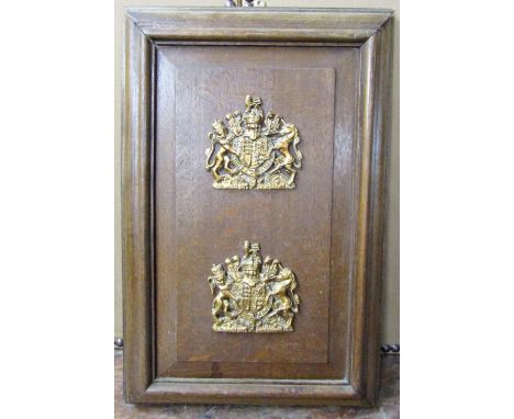 A rectangular oak panel supporting two painted plaster royal syphers, 75cm high 