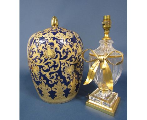 A blue ground oriental style vase and cover with gilt scrolling decoration, 37cm tall approx, together with a decorative flut