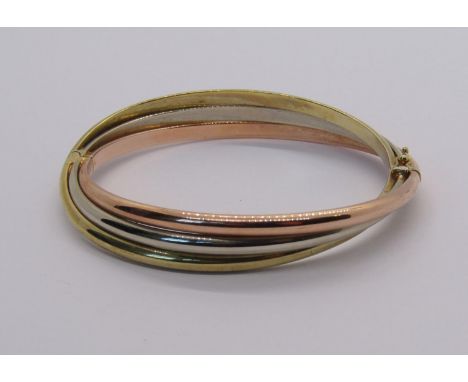 9ct tri-colour hinged bangle with double safety catch, maker 'MST', 17.2g 