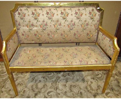 Two seat light weight parlour or salon sofa, with upholstered pad seat back and arms within a gilt frame with shaped outline 