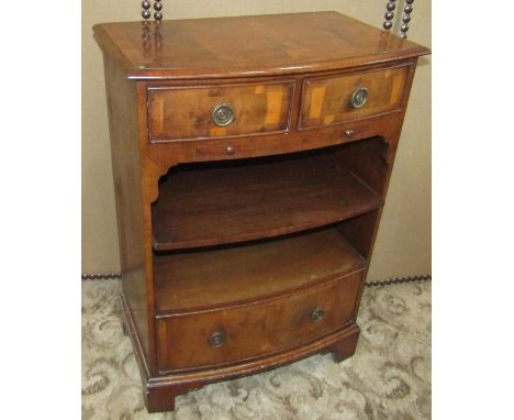 A small reproduction yew wood veneered bow fronted side cabinet in the Georgian style, the front elevation fitted with two fr