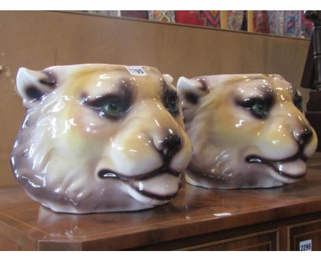 A pair of novelty glazed ceramic jardinières in the form of lions heads 