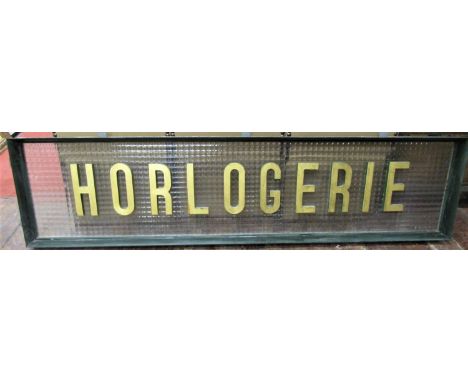 A large French shop panel, the letters Horlogerie in gilt block (watch making or Horology) mounted upon a glass panel within 
