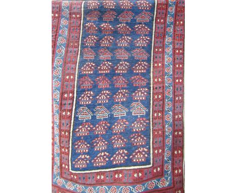 An antique Kazak design runner with a central panel of stylised flowers, 240cm x 90cm 