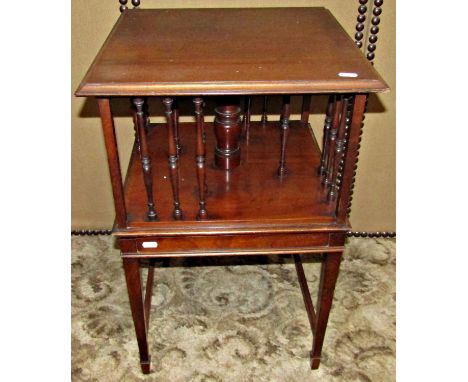 An Edwardian mahogany single tier revolving bookcase with turned spindle mouldings, raised on four square tapered supports, 4