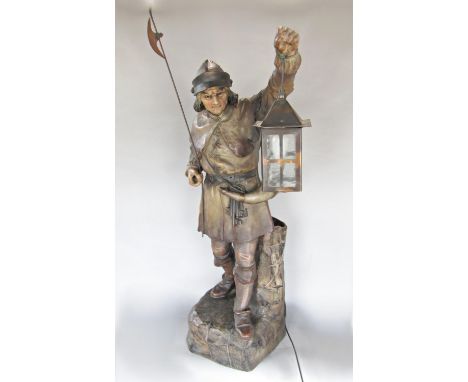 A terracotta figure of a night watchmen holding aloft his lamp 80 cm high approximately (in the Goldsheider style) 