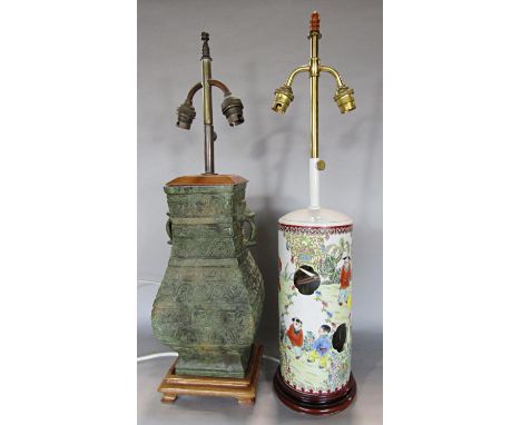 A Chinese style Verdi Gris bronze effect lamp base with a pagoda shaped shade, and a Chinese famille vert style lamp base wit