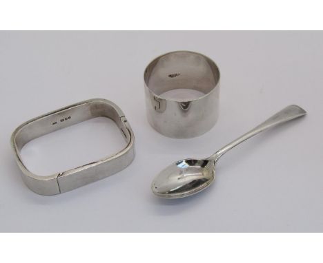 Group of silver comprising a hinged bangle, maker 'AMB', London 1975, a napkin ring and teaspoon (3) 