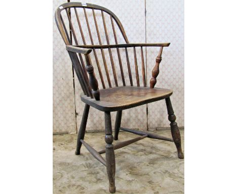 A 19th century Windsor low hoop and stick back elbow chair, principally in elm and ash 