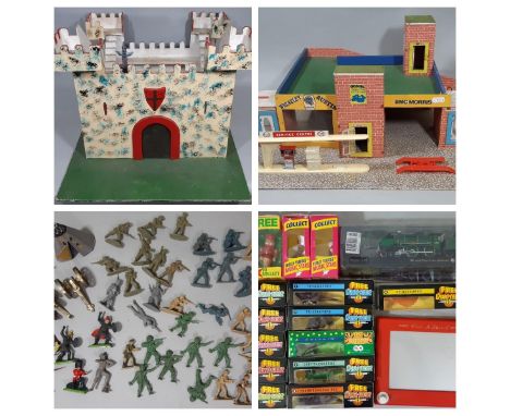 A collection of vintage toys including a model garage/petrol station on a base 61 x 46cm, with a hand built model fort height