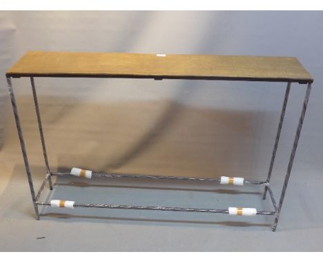 A contemporary bronze top console table raised on steel legs, H:80cm W:119cm D:25cm