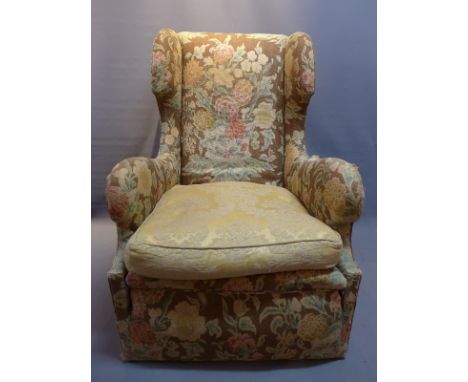 An early 20th Century wing back armchair with floral tapestry upholstery. 