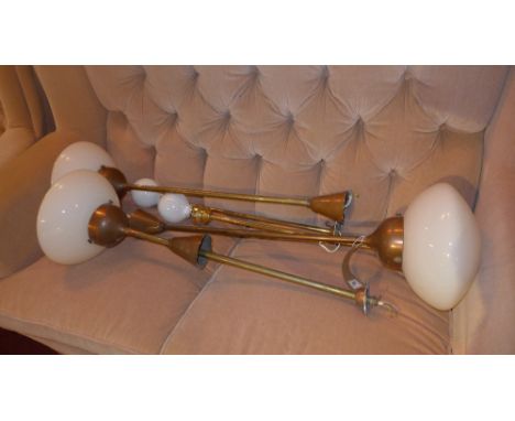 Three copper ceiling light fittings with large opaque glass shades together with a pair of brass examples. 