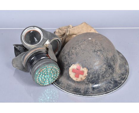 A WWII British Medic's Brodie Helmet, together with a gas mask in carry case (2) 