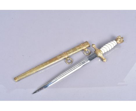 A German Kreigsmarine dagger by Eickhorn, maker's name to the blade, the double fullered 25cm long blade with etched design, 