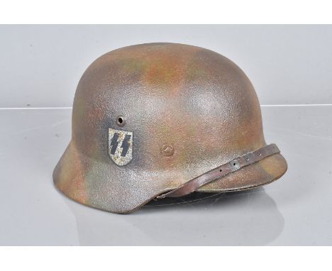 A WWII period German SS Single decal M40 helmet, with faded camo paint, replacement lugs, 'P. Schütz' hand painted to the inn